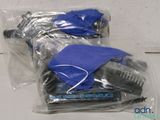 two bags of hairbrushes wrapped in plastic on a table