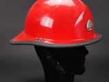 red hard hat on a mannequin head against a black background