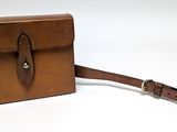 brown leather case with a strap on a white background