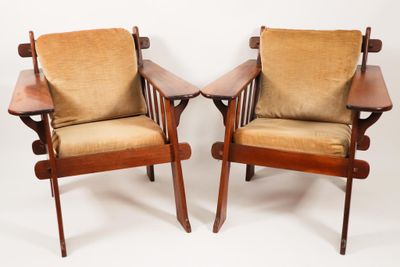 pair of mid - century danish lounge chairs with upholstered cushions