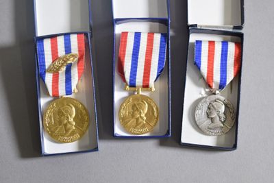 three medals that are in a box on a table
