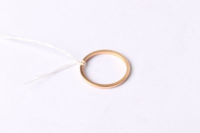 a close up of a gold ring on a white surface