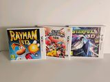 three nintendo wii games sitting on top of a white table
