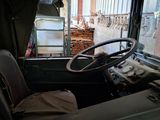 a view of the inside of a truck from the driver ' s seat