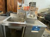 a sink and a dishwasher sitting in a room