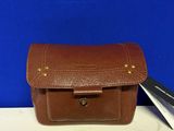 brown leather tool case with a pair of scissors next to it