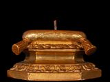 a gold statue on a black background with a black background