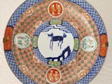 a plate with a picture of a horse and a bird on it