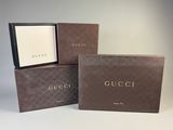 three boxes of gucci perfume sitting on top of each other