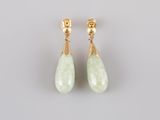 a pair of green jade earrings with gold accents