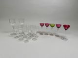 several wine glasses are lined up in a row on a white surface