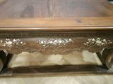a wooden table with a floral design on it