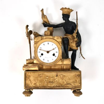 a gold clock with a man holding a bird on top of it