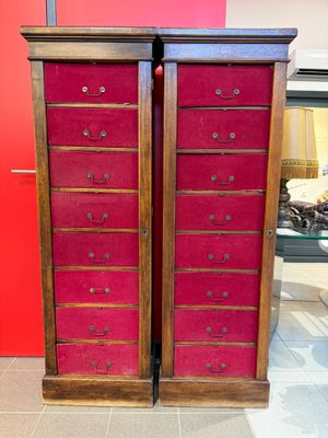 deux grands coffres en bois aux portes recouvertes de velours rouge dans un salon