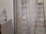 two ladders that are next to each other in a room