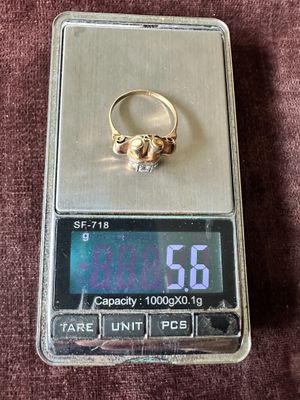 a gold ring sitting on top of a digital scale