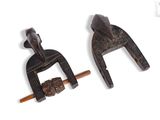 pair of old clamps on a white background with a wooden handle