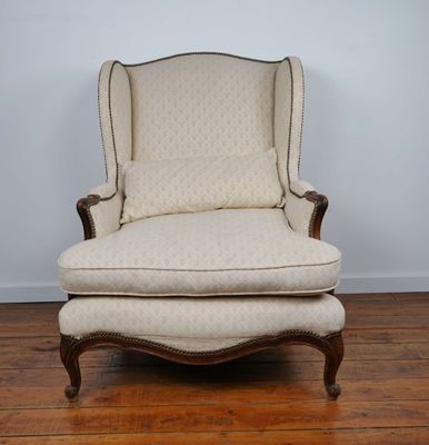 a chair and ottoman in a room with wood floors