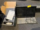 a laptop and a keyboard in a box on the floor