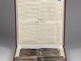 a set of six silverplated flatware knives in a case