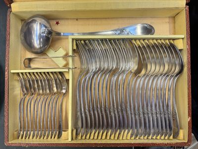 many forks and spoons in a box with a spoon in it