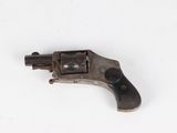 a close up of a revolver on a white surface