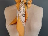 an image of a mannequin torso with a yellow scarf on it