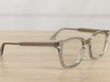 glasses on a wooden table with a white wall in the background