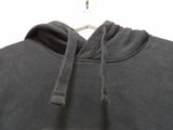 the back of a black hoodie with a white logo on it