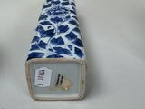 two blue and white vases sitting next to each other