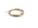 a close up of a gold ring on a white surface