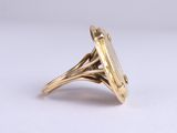 a close up of a gold ring with a stone in the middle