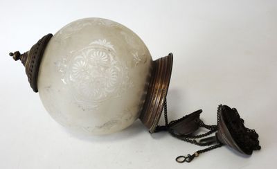 a white ball with a chain around it on a white surface