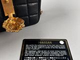 a close up of a black purse with a gold handle