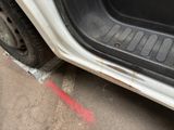 a white car with a red line painted on the side of it