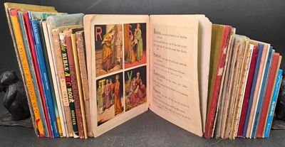 an open book with a bunch of books in it on a table