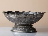 a silver bowl that is sitting on a table