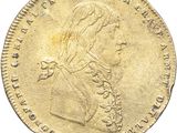 a close up of a gold coin on a white background