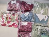 de nombreux types de vêtements, rangés dans des sacs posés sur la table