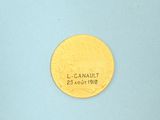 an image of a gold coin on a blue surface with the word l canaut on it