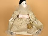 an image of a doll sitting on top of a table