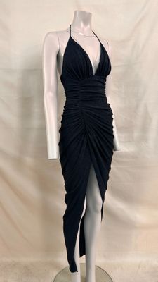 the mannequin is wearing a black dress with a high slit