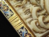 a picture of a picture of a dragon on a gold and blue plate