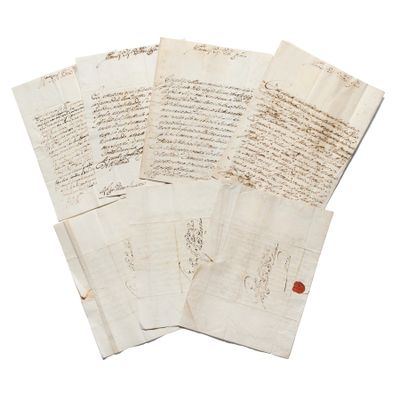 several pieces of old paper with writing on them on a white surface