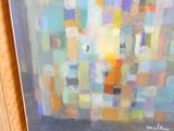 une peinture à l'huile représentant un paysage urbain, encadrée et accrochée au mur
