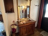 a mirror that is on the side of a wooden cabinet