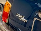 a close up of a blue car with the word hell school on it