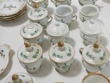 a table with a lot of china and dishes on it