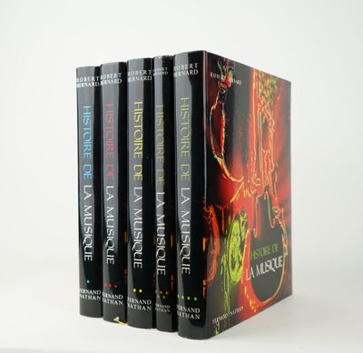 three books are stacked on top of each other on a white surface