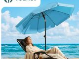 an image of a woman sitting on a beach chair under an umbrella